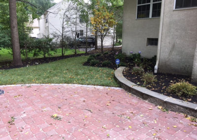 Backyard with paved stone patio installed by Moorestown NJ contractor