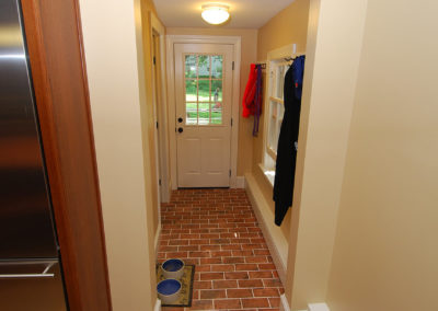 Mud room hallway remodel with coat rack storage