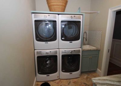 Laundry Room Double Stacked Washers and Dryers