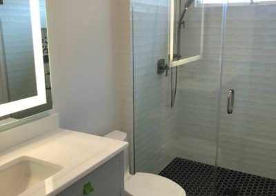 Remodeled Bathroom with tiled floor and new vanity