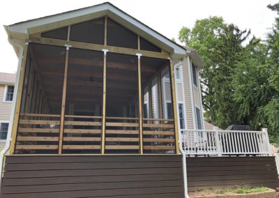 Enclosed porch and deck extend outdoor living in this Moorestown, NJ home