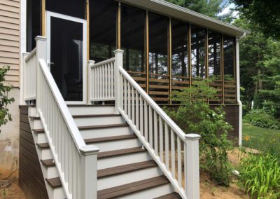 Custom staircase off the screened-in deck leads to the backyard