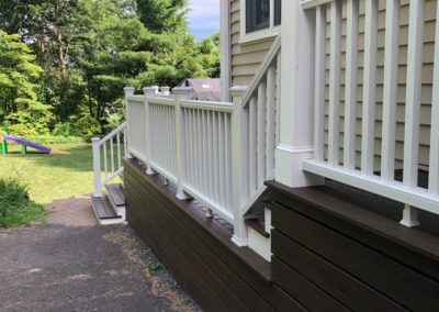 Side entry porch features composite deck flooring