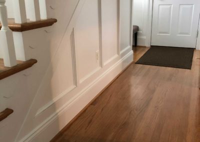 Custom wainscoting and trim work adorn the traditional style staircase