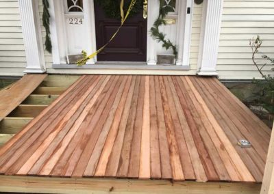 Replacing old porch boards with new wood planks