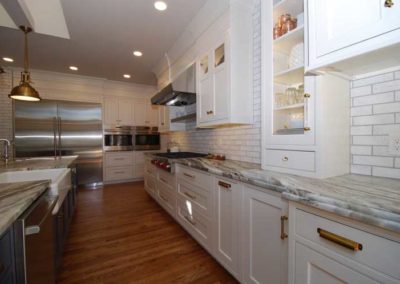 Cook's kitchen features a custom farmhouse sink in the center island