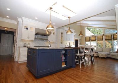 Open kitchen features custom center island with prep sink