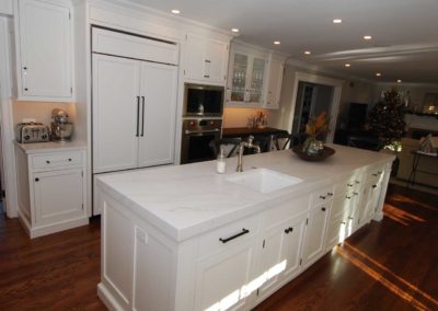 Spacious white kitchen with marble counter tops and hardwood flooring by Moorestown NJ contractor