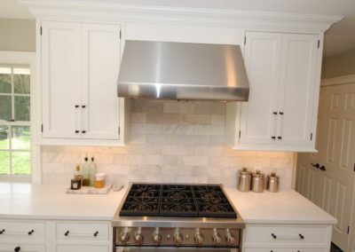 Classic white cabinets with black hardware and decorative backsplash installed by local Moorestown NJ company