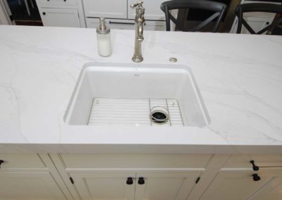 Remodeled kitchen with bar sink in center island with marble countertop by Moorestown NJ home remodeling