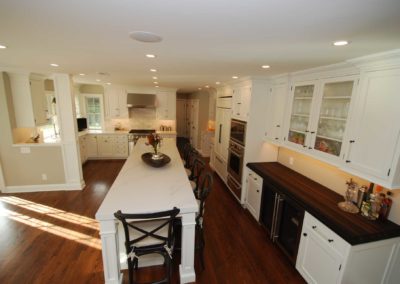 Traditional Kitchen remodel with long marble-top island and butcher block prep counter