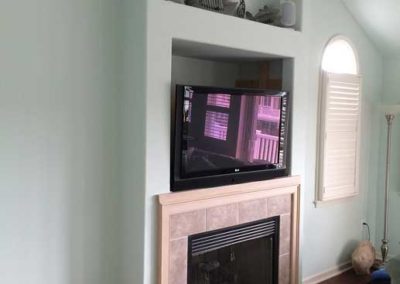Custom wall niche above fireplace for TV media center