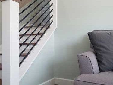 Simple modern railing by local contractor transforms this family room staircase
