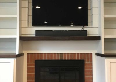 A built in media center fireplace surround by Moorestown NJ home remodeling company transforms this living room